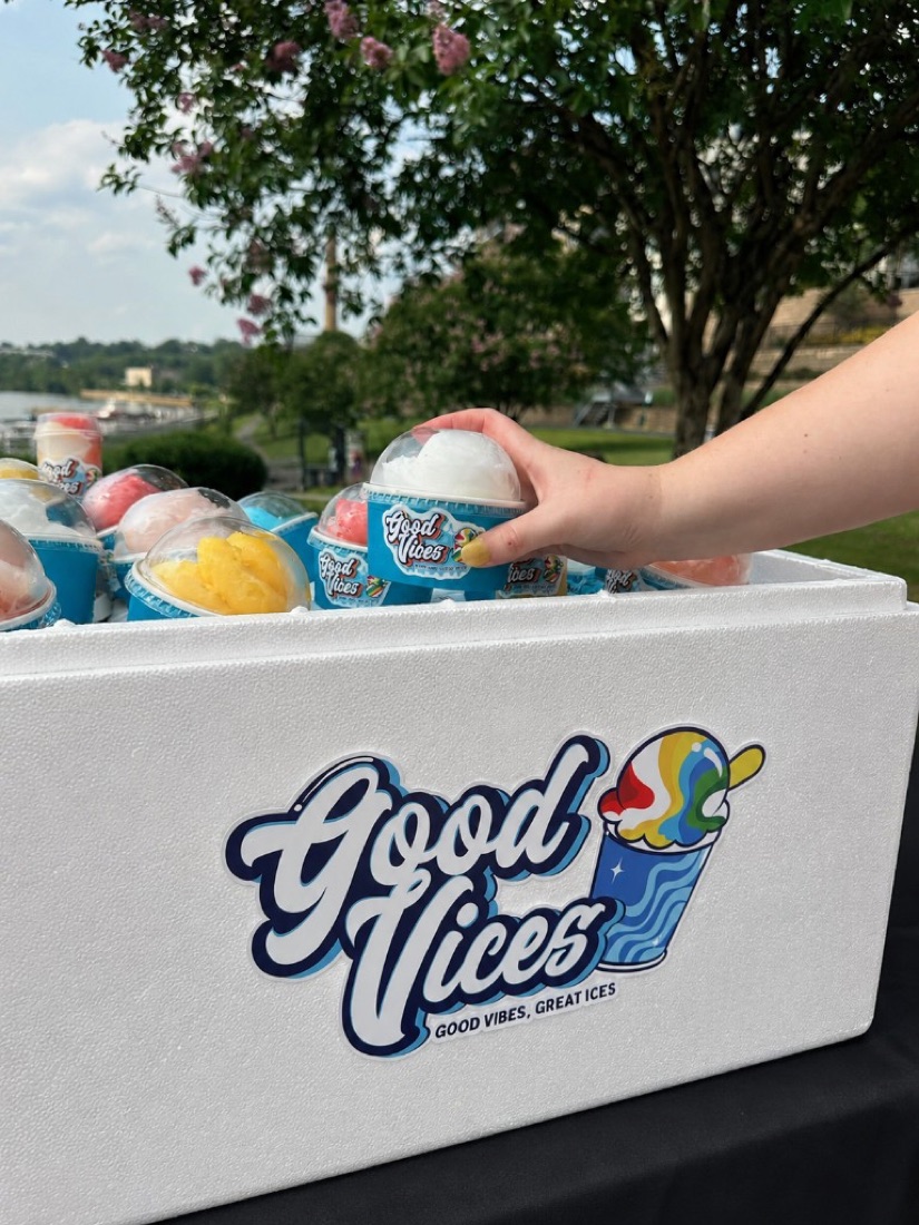 Guest grabbing a pre-scooped Italian ice cup from the Good Vices foam cooler